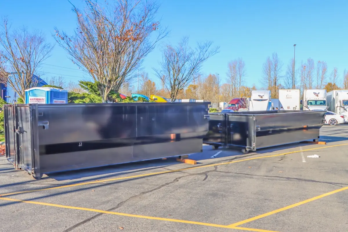 Professional dumpster rental service with roll-off container on residential driveway in Telford